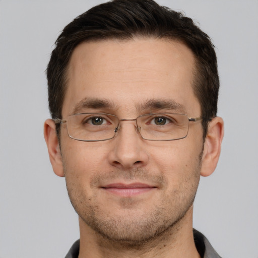 Joyful white adult male with short  brown hair and brown eyes