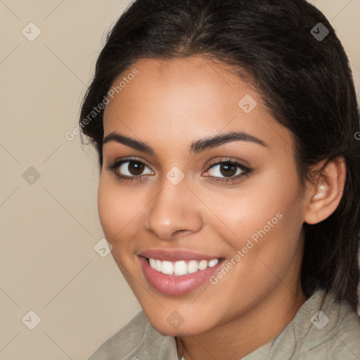 Joyful latino young-adult female with long  brown hair and brown eyes