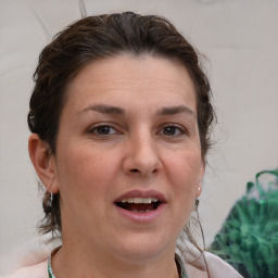 Joyful white adult female with short  brown hair and brown eyes