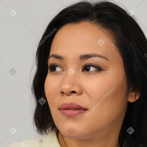 Joyful asian young-adult female with long  brown hair and brown eyes