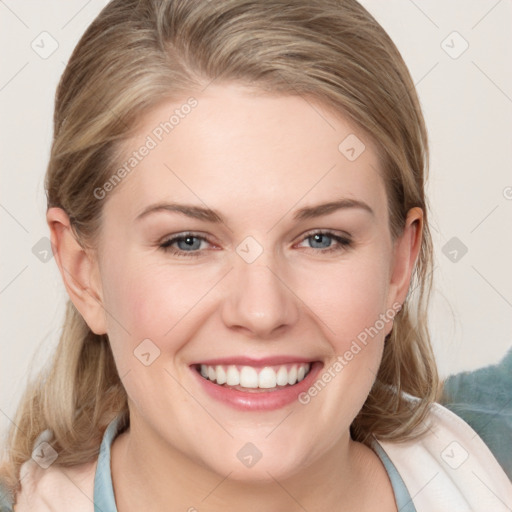 Joyful white young-adult female with medium  brown hair and blue eyes