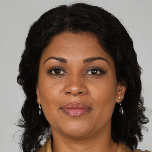 Joyful black adult female with medium  brown hair and brown eyes
