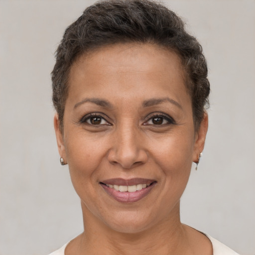 Joyful white adult female with short  brown hair and brown eyes