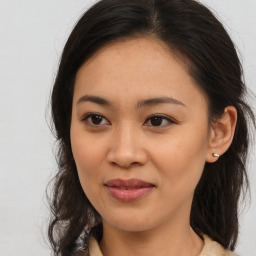 Joyful asian young-adult female with medium  brown hair and brown eyes