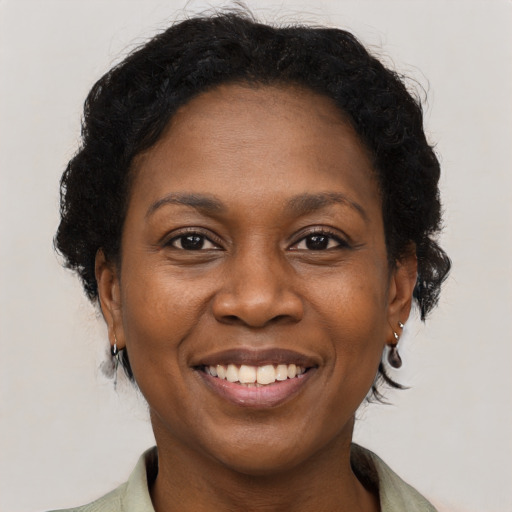 Joyful black adult female with short  brown hair and brown eyes