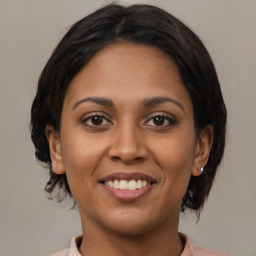 Joyful latino young-adult female with medium  brown hair and brown eyes