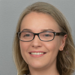 Joyful white young-adult female with long  brown hair and blue eyes