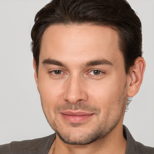 Joyful white young-adult male with short  brown hair and brown eyes