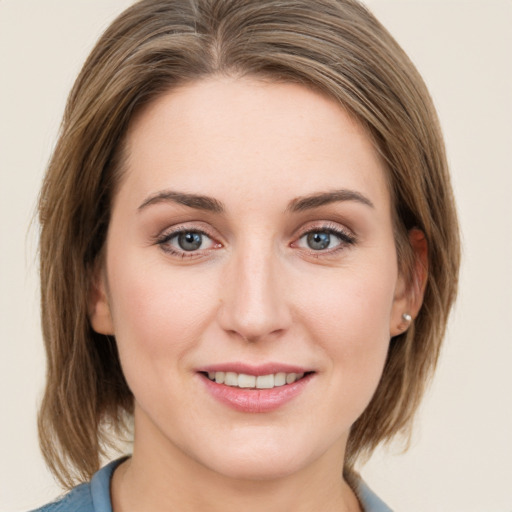 Joyful white young-adult female with medium  brown hair and grey eyes