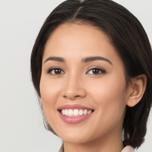 Joyful white young-adult female with long  black hair and brown eyes