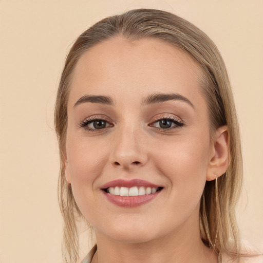 Joyful white young-adult female with long  brown hair and brown eyes