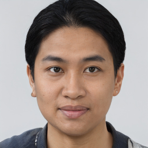 Joyful asian young-adult male with short  brown hair and brown eyes