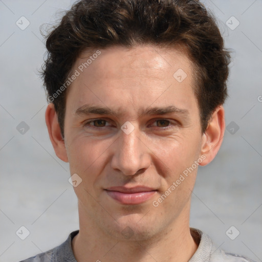 Joyful white adult male with short  brown hair and grey eyes