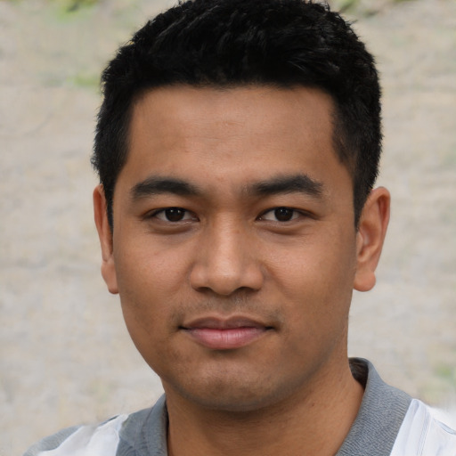 Joyful asian young-adult male with short  black hair and brown eyes