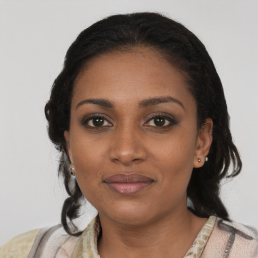 Joyful black young-adult female with medium  black hair and brown eyes