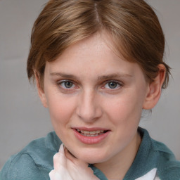 Joyful white young-adult female with medium  brown hair and blue eyes