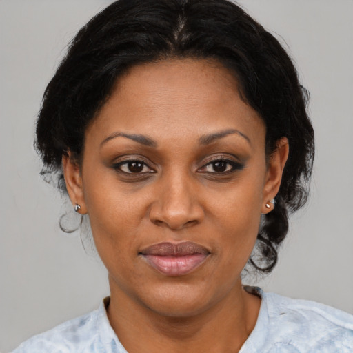 Joyful latino adult female with medium  brown hair and brown eyes