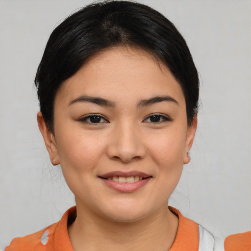 Joyful white young-adult female with medium  black hair and brown eyes