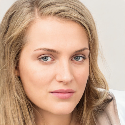 Joyful white young-adult female with long  brown hair and green eyes