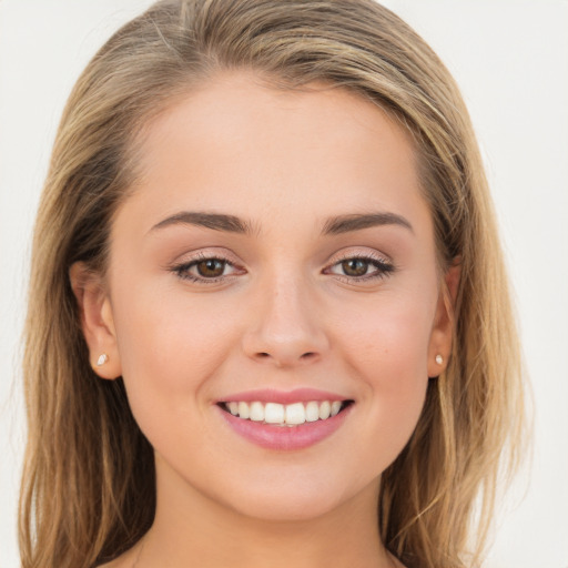 Joyful white young-adult female with long  brown hair and brown eyes