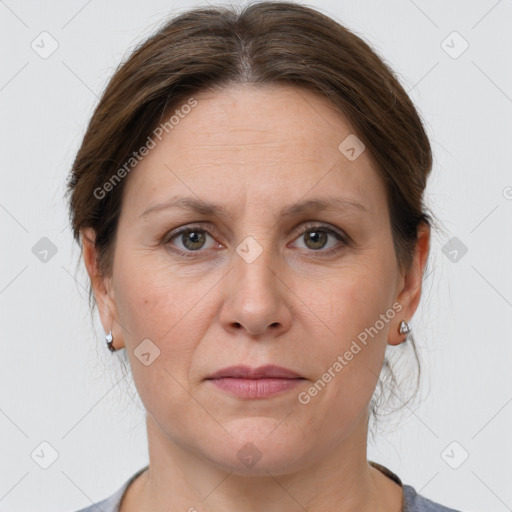 Joyful white adult female with medium  brown hair and grey eyes