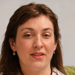 Joyful white adult female with medium  brown hair and grey eyes