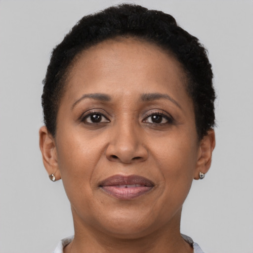 Joyful black adult female with short  brown hair and brown eyes