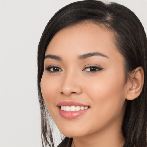 Joyful white young-adult female with long  black hair and brown eyes