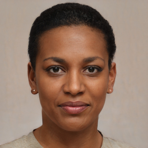 Joyful black young-adult female with short  black hair and brown eyes