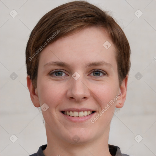 Joyful white young-adult female with short  brown hair and grey eyes