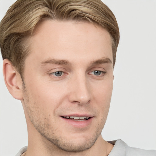 Joyful white young-adult male with short  brown hair and grey eyes