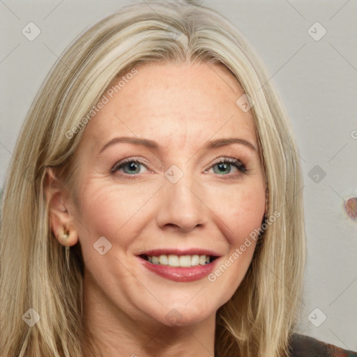 Joyful white adult female with long  brown hair and blue eyes