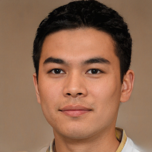 Joyful asian young-adult male with short  black hair and brown eyes