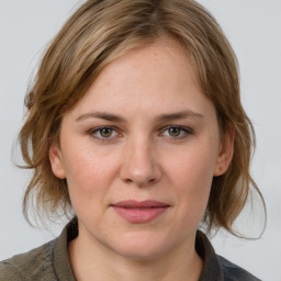 Joyful white young-adult female with medium  brown hair and blue eyes