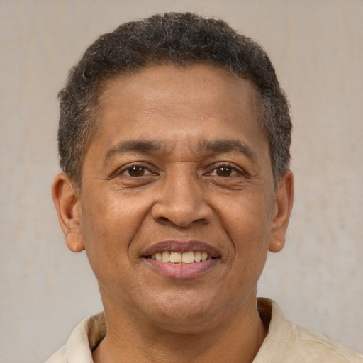 Joyful latino adult male with short  brown hair and brown eyes