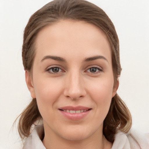 Joyful white young-adult female with medium  brown hair and grey eyes