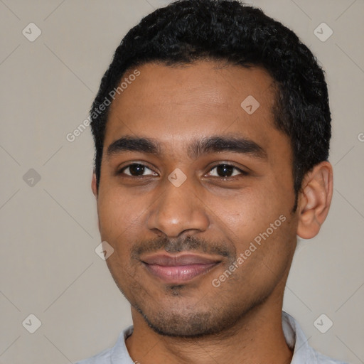 Joyful black young-adult male with short  black hair and brown eyes