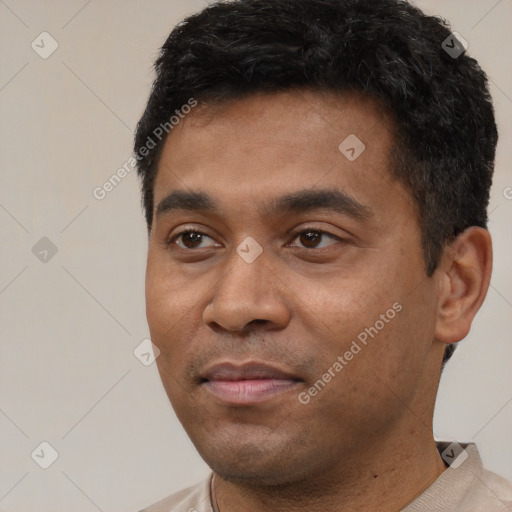 Joyful latino young-adult male with short  black hair and brown eyes