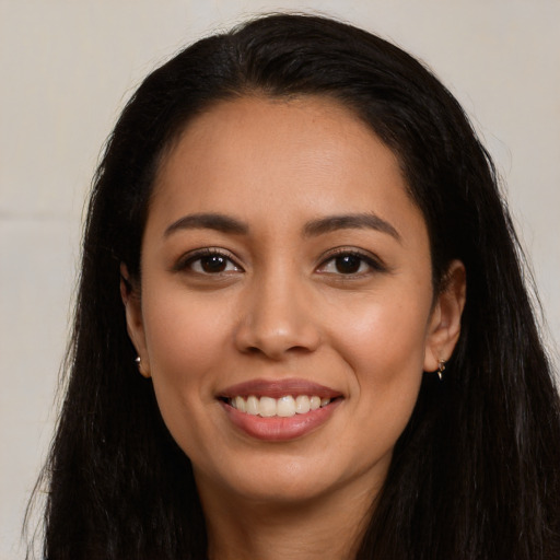 Joyful latino young-adult female with long  black hair and brown eyes