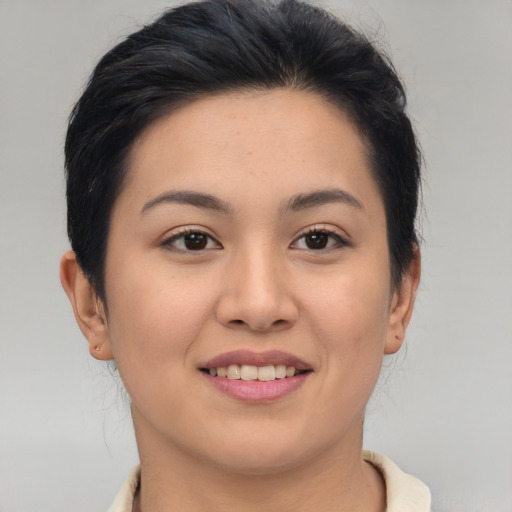 Joyful asian young-adult female with short  brown hair and brown eyes