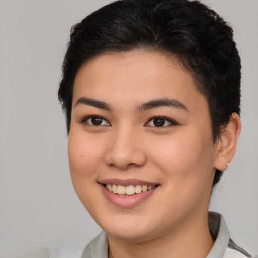 Joyful asian young-adult female with short  brown hair and brown eyes