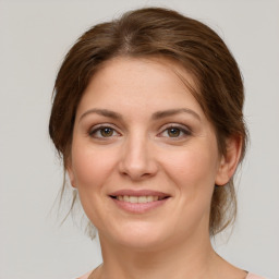 Joyful white young-adult female with medium  brown hair and green eyes