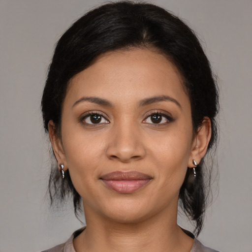 Joyful latino young-adult female with medium  black hair and brown eyes