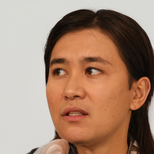Joyful asian adult male with medium  brown hair and brown eyes
