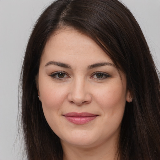 Joyful white young-adult female with long  brown hair and brown eyes