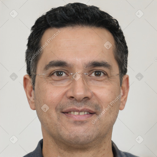 Joyful white adult male with short  black hair and brown eyes