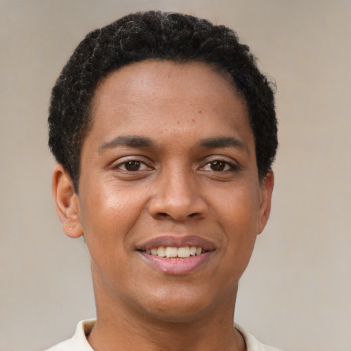 Joyful black young-adult male with short  brown hair and brown eyes