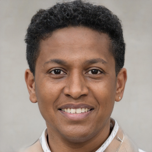 Joyful latino young-adult male with short  brown hair and brown eyes