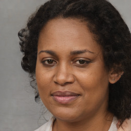 Joyful black adult female with medium  brown hair and brown eyes