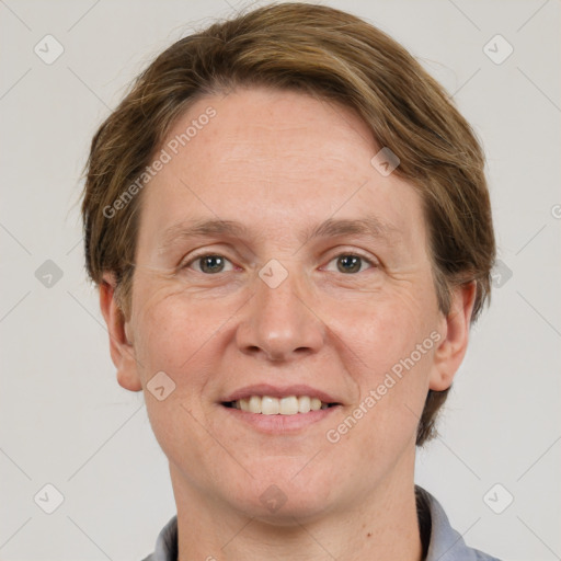 Joyful white adult female with short  brown hair and grey eyes